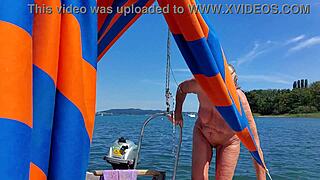 A mature woman completely naked on a sailboat